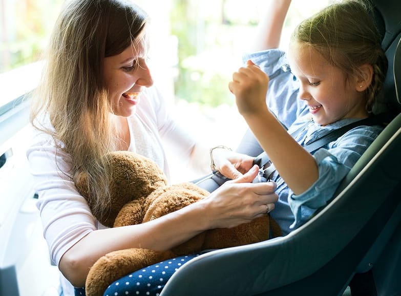 mom installing car seat